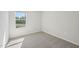 Bedroom with a large window offering lots of light and neutral decor at 713 Chandler Stone Dr, Zebulon, NC 27597