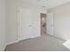 Bedroom with open doorway and neutral walls and carpet at 713 Chandler Stone Dr, Zebulon, NC 27597