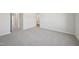 Large bedroom with neutral carpet and paint has doorways to other rooms and bathroom at 713 Chandler Stone Dr, Zebulon, NC 27597