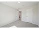 A view of an empty bedroom with carpet, an open door, and an adjacent closet at 713 Chandler Stone Dr, Zebulon, NC 27597