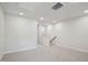 Well-lit bonus room with carpet and neutral walls, showing stairs and a hallway at 713 Chandler Stone Dr, Zebulon, NC 27597