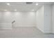 Bright bonus room features neutral carpet and paint, recessed lights and staircase at 713 Chandler Stone Dr, Zebulon, NC 27597