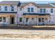 Unfinished new construction townhomes with black roof and Tyvek wrap ready for customization and personalization at 713 Chandler Stone Dr, Zebulon, NC 27597