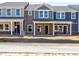 New construction townhomes feature brick accents, covered entryways, and neutral color schemes at 713 Chandler Stone Dr, Zebulon, NC 27597