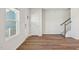 Welcoming foyer with hardwood flooring, a staircase, and a front door, creating an inviting entrance to the home at 713 Chandler Stone Dr, Zebulon, NC 27597