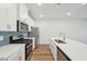 Bright kitchen with white cabinets, stainless steel appliances, and a center island at 713 Chandler Stone Dr, Zebulon, NC 27597