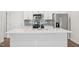Bright kitchen with white cabinets, stainless steel appliances, and a large center island at 713 Chandler Stone Dr, Zebulon, NC 27597