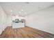 Bright, open concept kitchen featuring stainless steel appliances, white cabinetry, and hardwood floors at 713 Chandler Stone Dr, Zebulon, NC 27597