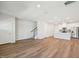Spacious living room with hardwood floors, an open layout, and modern finishes connecting living and kitchen areas at 713 Chandler Stone Dr, Zebulon, NC 27597