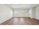Bright living room with hardwood floors, natural light, and a welcoming entrance door at 713 Chandler Stone Dr, Zebulon, NC 27597
