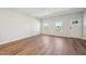 Bright living room with hardwood floors, natural light, and a welcoming entrance door at 713 Chandler Stone Dr, Zebulon, NC 27597