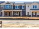 Newly constructed townhomes featuring varied exterior paint colors and brick foundations at 715 Chandler Stone Dr, Zebulon, NC 27597