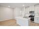 Kitchen with central island, stainless steel appliances, white cabinets, and plenty of countertop space at 715 Chandler Stone Dr, Zebulon, NC 27597