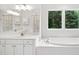 Bright bathroom with tub, vanity, sinks, and a great view at 802 Windermere Lake Ct, Apex, NC 27502