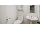 Powder room features pedestal sink, toilet, and cabinet with mirror at 802 Windermere Lake Ct, Apex, NC 27502