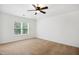 Neutral bedroom with ceiling fan, closet, and carpet flooring at 802 Windermere Lake Ct, Apex, NC 27502