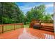 Spacious wooden deck with steps down to the backyard and a large storage box at 802 Windermere Lake Ct, Apex, NC 27502