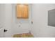 A clean laundry room with overhead cabinet and vinyl flooring at 802 Windermere Lake Ct, Apex, NC 27502