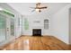 Cozy living room featuring hardwood floors, a fireplace, and a built-in bookcase at 802 Windermere Lake Ct, Apex, NC 27502