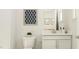 Bright bathroom with white cabinetry, modern fixtures, and decorative accents at 808 Emerald Bay Cir, Raleigh, NC 27610