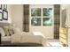 Bright bedroom featuring a large window with natural light and soft, neutral decor at 808 Emerald Bay Cir, Raleigh, NC 27610