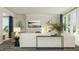 Bright living room with white sofa, large windows, fireplace, decorative shelving, and modern accents at 808 Emerald Bay Cir, Raleigh, NC 27610