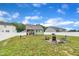 Spacious backyard featuring a fire pit area, patio, and white vinyl fence, perfect for entertaining at 9 Little Sunshine Brk, Smithfield, NC 27577
