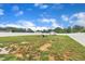 Wide open backyard featuring partial white fencing, shed, fire pit and plenty of room to entertain at 9 Little Sunshine Brk, Smithfield, NC 27577
