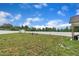 Large backyard featuring a shed, fire pit, partial fencing and lush green grass under a clear blue sky at 9 Little Sunshine Brk, Smithfield, NC 27577