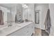 Bathroom has a double sink vanity with white cabinets, a soaking tub, and tiled floors at 9 Little Sunshine Brk, Smithfield, NC 27577