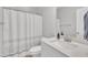 Bathroom featuring a shower with a patterned curtain and a white single sink vanity at 9 Little Sunshine Brk, Smithfield, NC 27577