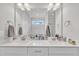 Bright bathroom featuring a double sink vanity with white cabinets and quartz countertops at 9 Little Sunshine Brk, Smithfield, NC 27577