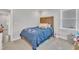 Cozy carpeted bedroom with neutral walls, a wood headboard bed, and bright natural light from a window at 9 Little Sunshine Brk, Smithfield, NC 27577
