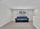 Neutral bonus room with a comfortable sofa, window and recessed lighting at 9 Little Sunshine Brk, Smithfield, NC 27577