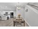 Dining room open to kitchen featuring modern light fixture and neutral paint at 9 Little Sunshine Brk, Smithfield, NC 27577