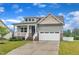 Charming home with an attached two-car garage, a welcoming porch, and a well-manicured front yard at 9 Little Sunshine Brk, Smithfield, NC 27577