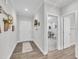 Bright hallway with wood floors, white trim, and decorative accents, leading to other rooms at 9 Little Sunshine Brk, Smithfield, NC 27577