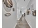 Long hallway with wood floors, neutral walls, and decorative wall art, extending into the home at 9 Little Sunshine Brk, Smithfield, NC 27577