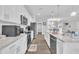 Bright kitchen boasts white cabinets, granite countertops, and stainless steel appliances at 9 Little Sunshine Brk, Smithfield, NC 27577