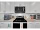 Close up of kitchen appliances with white cabinets and granite countertops at 9 Little Sunshine Brk, Smithfield, NC 27577