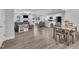 Open concept living area featuring fireplace, hardwood floors, and eat in kitchen with black stainless appliances at 9 Little Sunshine Brk, Smithfield, NC 27577