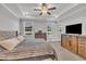 Bedroom featuring a tray ceiling, ceiling fan, large windows, and neutral carpeting at 9 Little Sunshine Brk, Smithfield, NC 27577