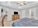 Comfortable bedroom features a tray ceiling, ceiling fan, a TV and a view into the ensuite bathroom at 9 Little Sunshine Brk, Smithfield, NC 27577