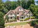 Stunning aerial view of a two-story home with a well-manicured lawn and mature trees at 90021 Hoey, Chapel Hill, NC 27517