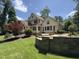Well-maintained backyard with a stone retaining wall and lush landscaping at 90021 Hoey, Chapel Hill, NC 27517