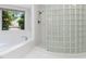 This bathroom has a soaking tub next to a window and a glass brick shower stall at 90021 Hoey, Chapel Hill, NC 27517