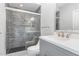 This bathroom features a glass enclosed shower and a gray vanity with white countertop at 90021 Hoey, Chapel Hill, NC 27517