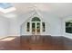 A bedroom with hardwood floors, large windows and a french door leading to a small balcony at 90021 Hoey, Chapel Hill, NC 27517