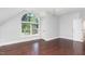 Bedroom features a hardwood floor, large window, and a ceiling fan at 90021 Hoey, Chapel Hill, NC 27517