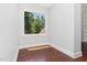 The bedroom features hardwood floors and a window with outdoor views at 90021 Hoey, Chapel Hill, NC 27517